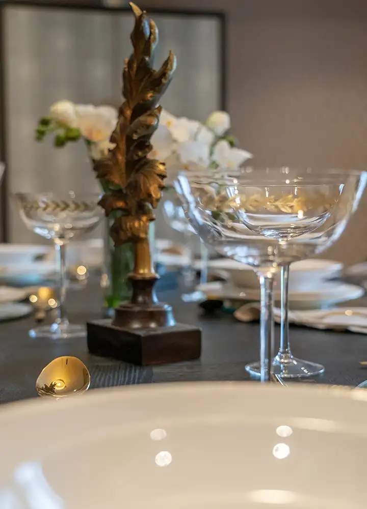 Elegant dining table setup with glassware and decor.