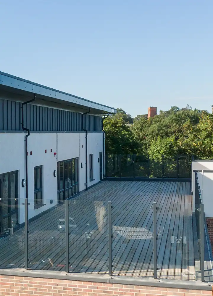 Outdoor deck area with railing and green trees