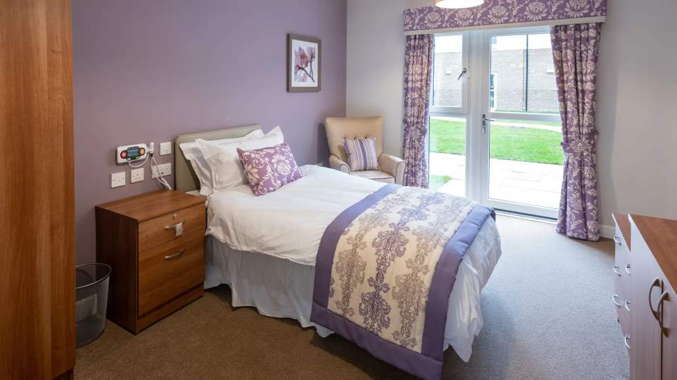 Cozy bedroom with purple decor and natural light