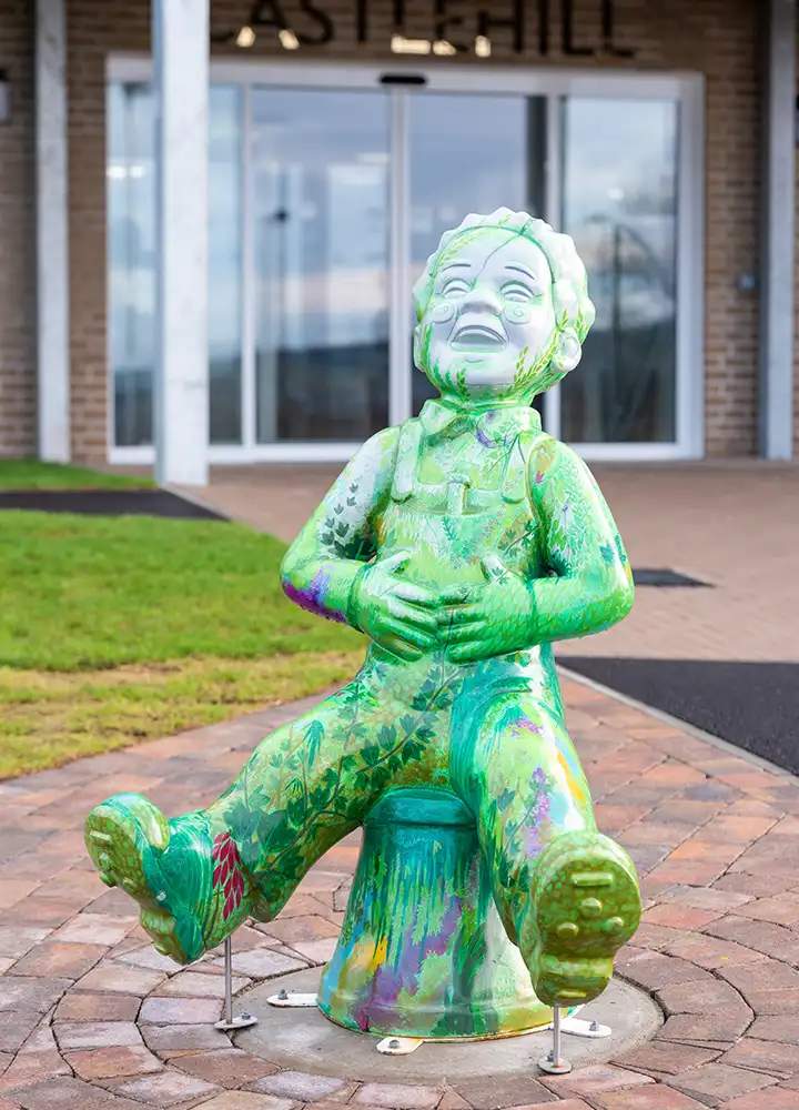 Colorful statue in front of the facility building
