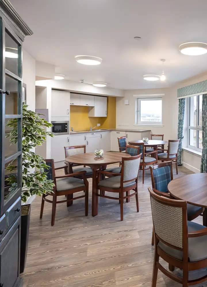 Common area with tables and chairs in the facility