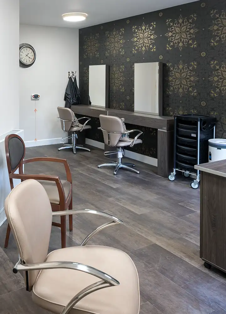 Hair salon area with styling chairs and mirrors