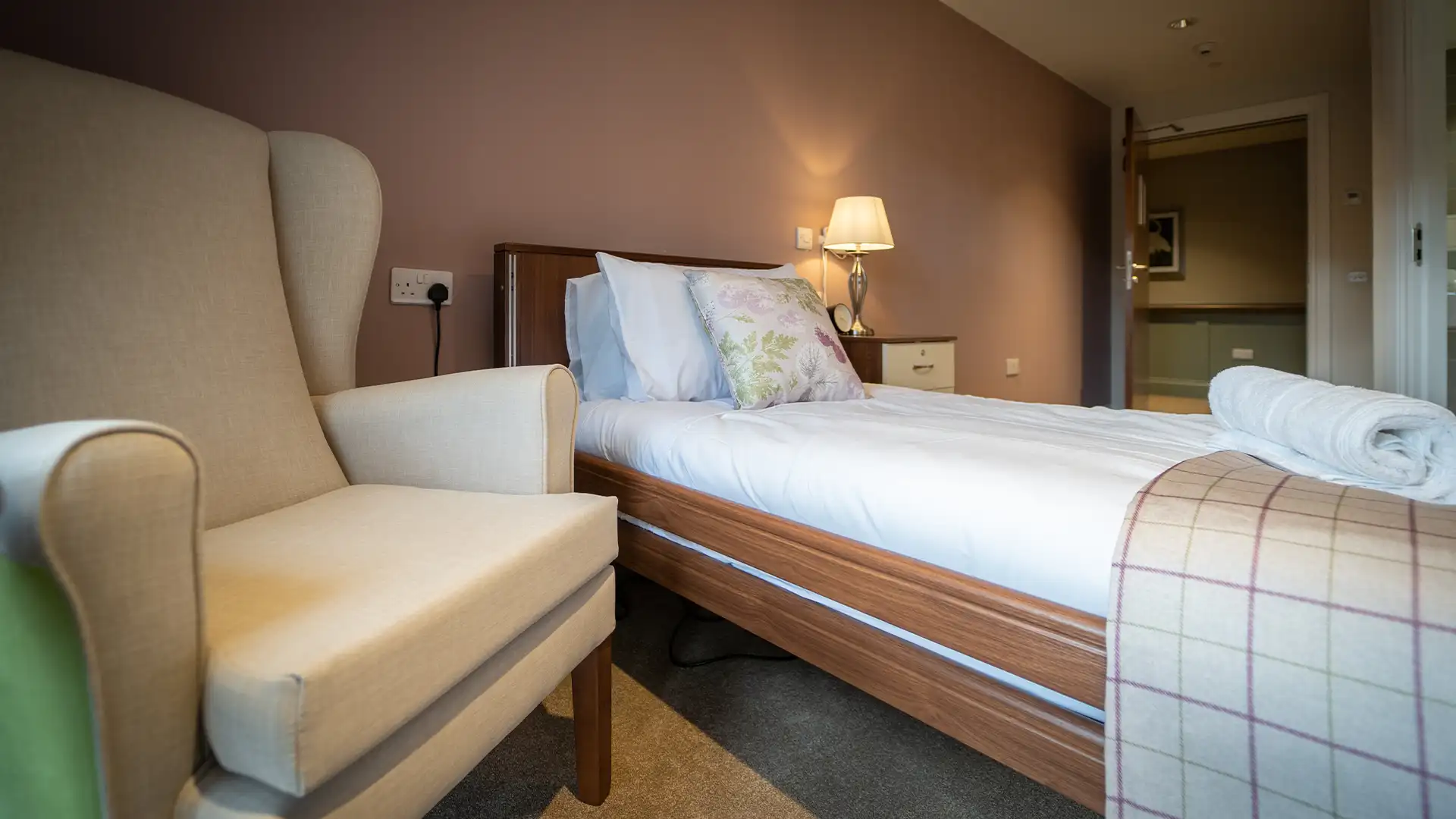 Cozy private resident room with a bed and chair