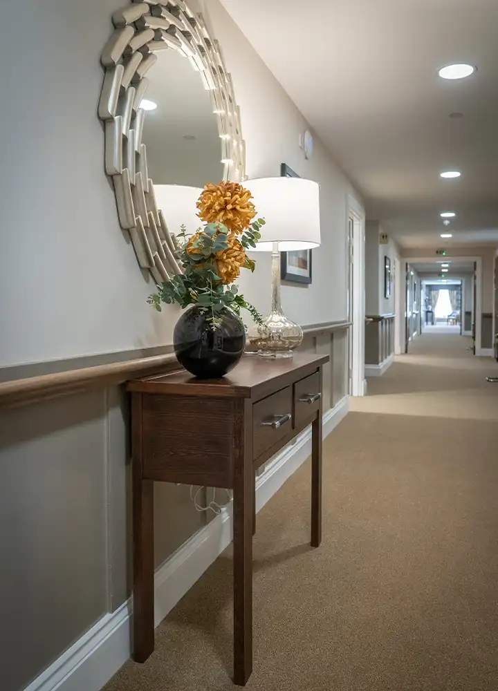 Decorative hallway with a console table and lamp