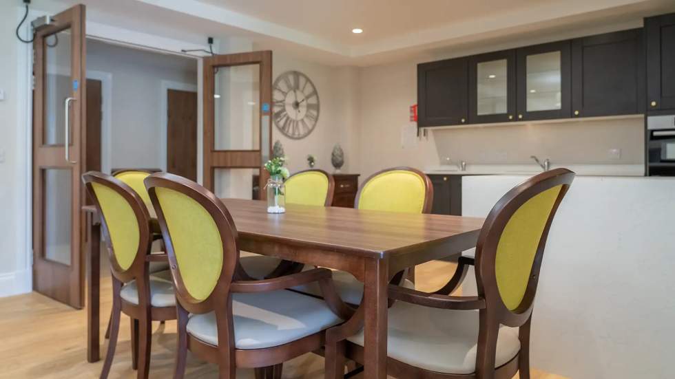 Dining area with a wooden table and yellow chairs