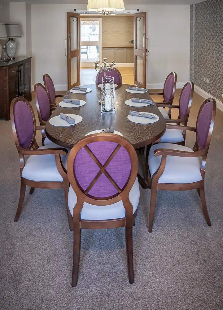 Elegant dining room with large wooden table.