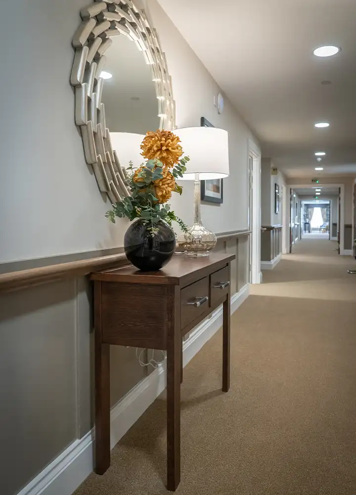 Decorative hallway with a table and lamp