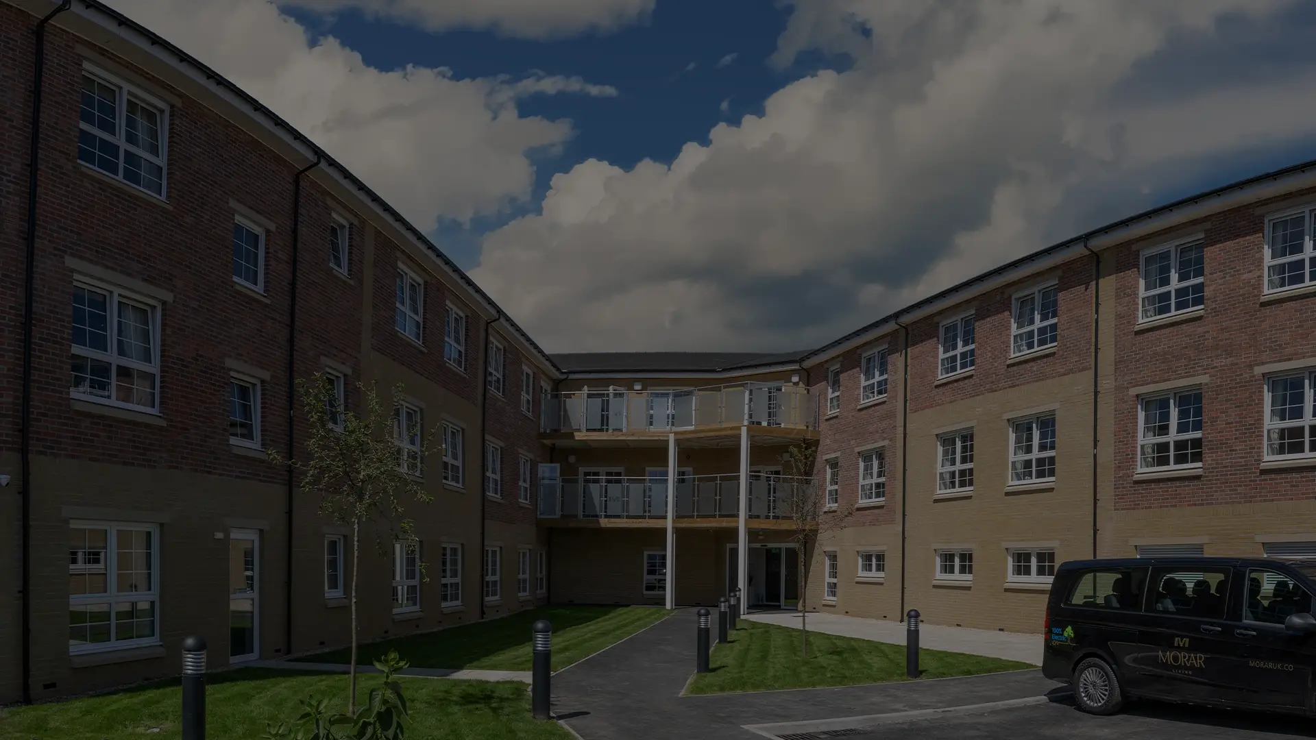 Exterior view of Escan Manor with green space.