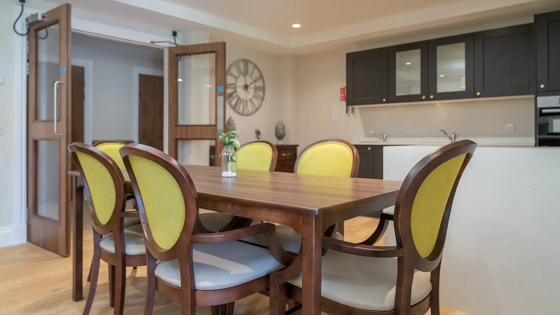 Bright dining area with wooden table and chairs.