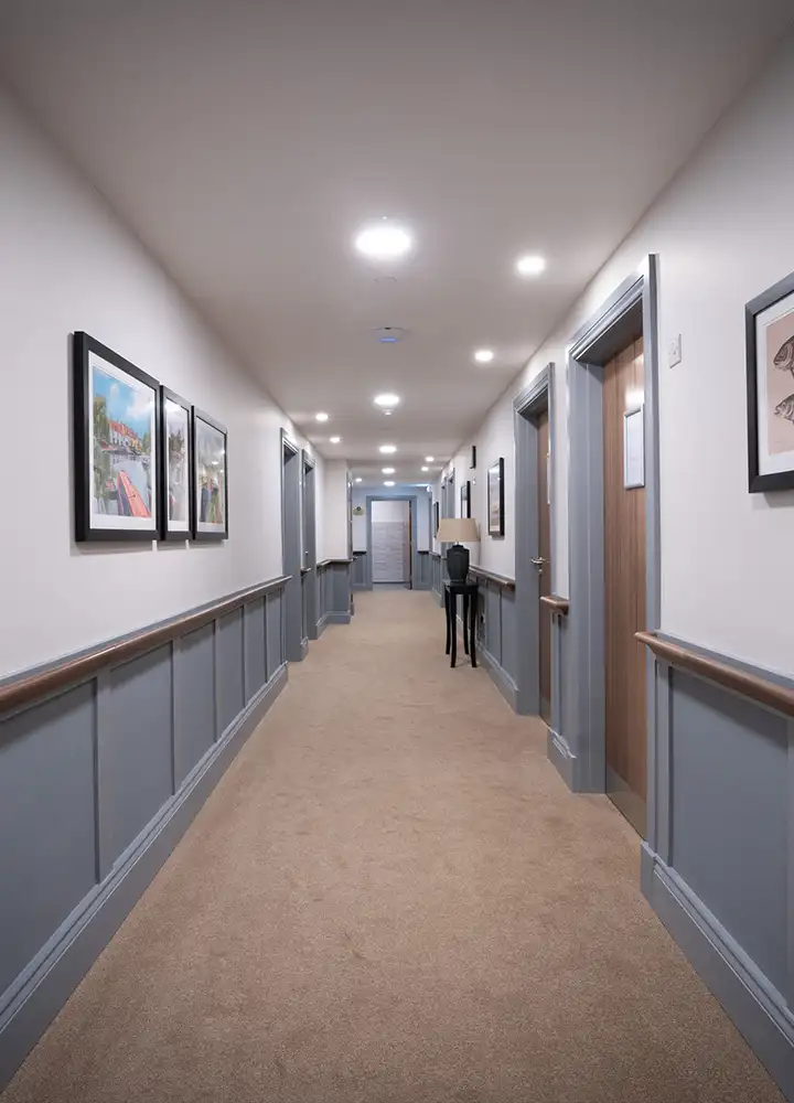 Interior hallway with framed artwork and doors