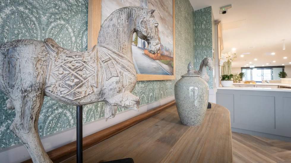 Interior decor featuring a horse sculpture and vase.
