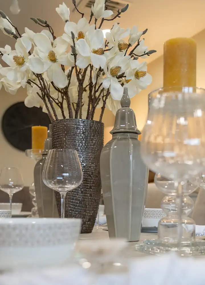Elegant dining table setup with flowers and candles.