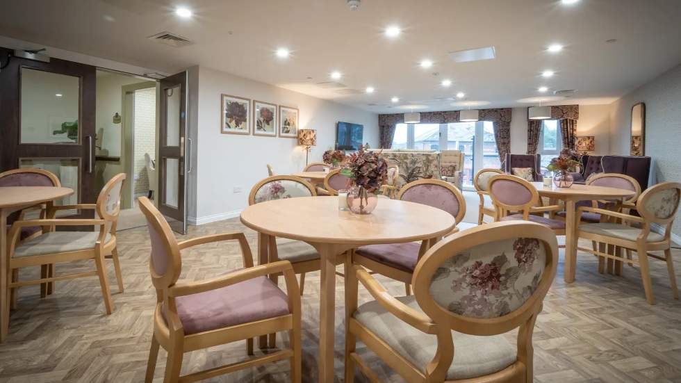 Warm and inviting common area with round tables.