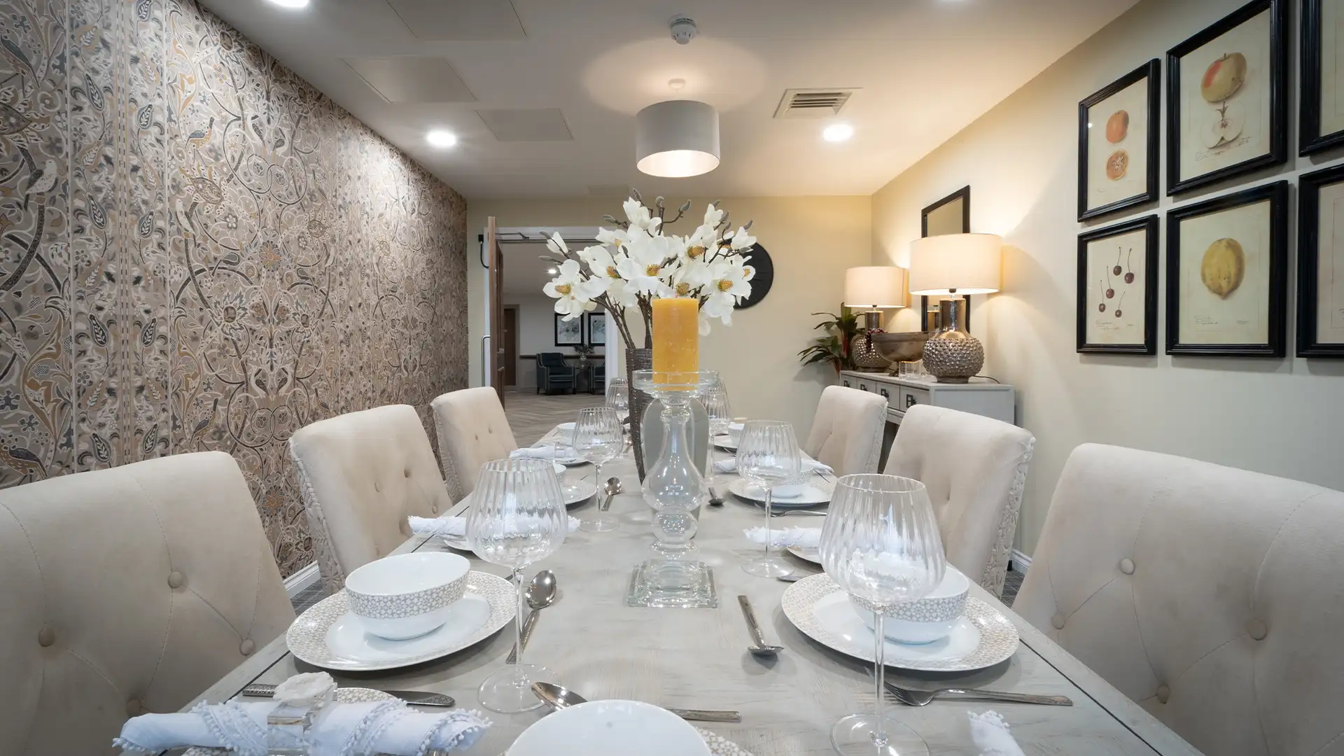 Elegant dining room setup with flowers and tableware.