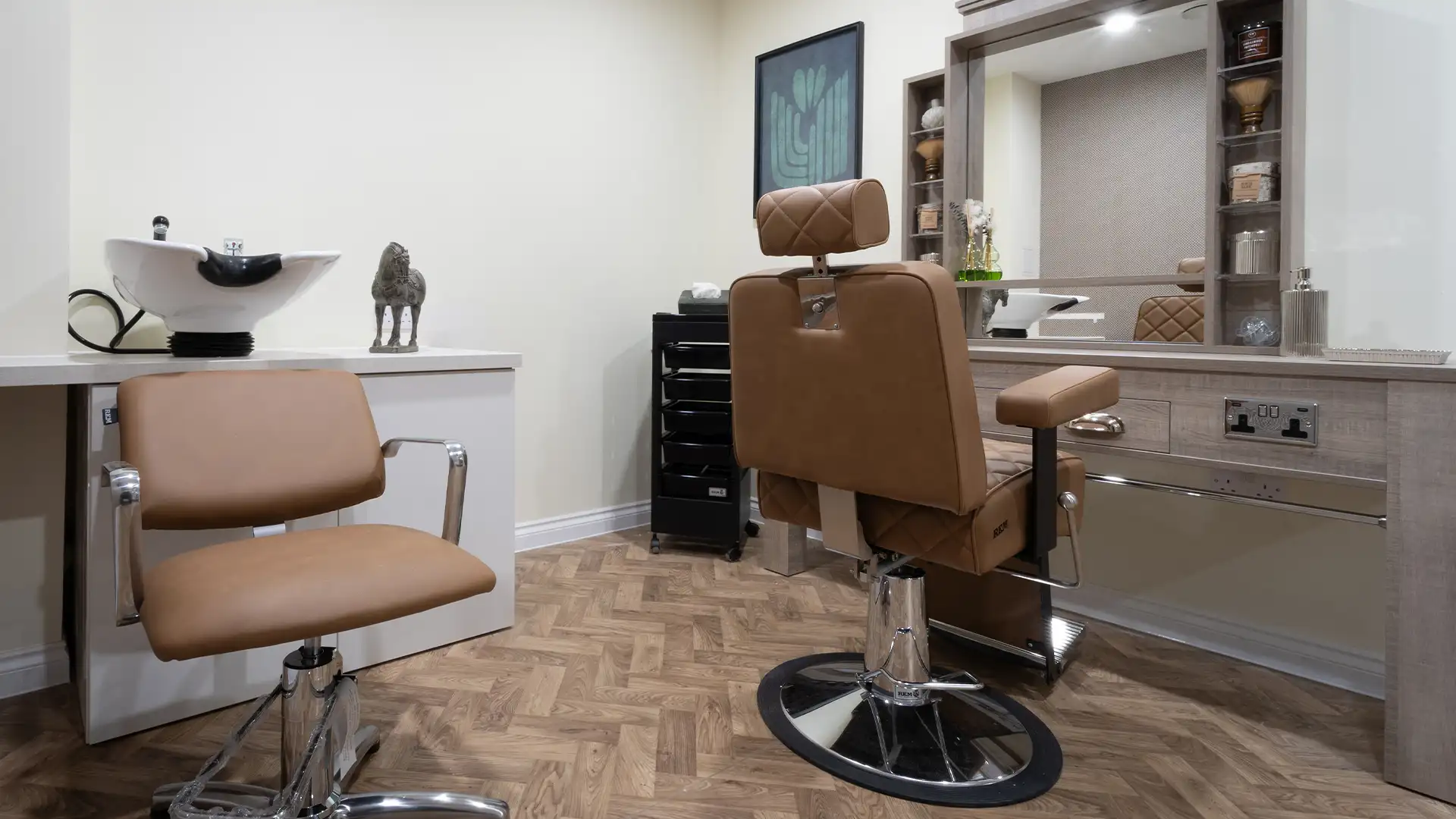 Hair salon area with styling chairs and mirror