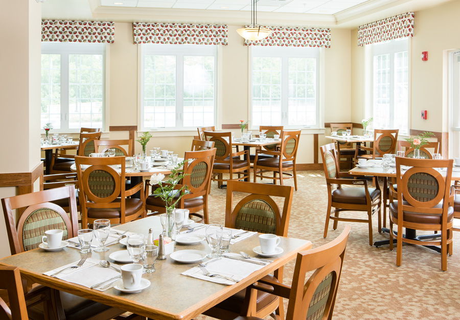 Dining area with neatly set tables and sunlight