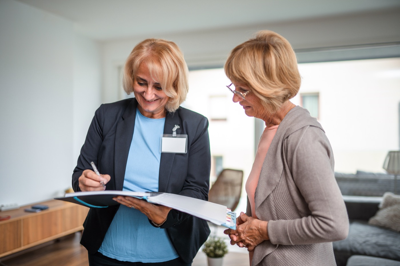 Staff member assisting a resident in a common area