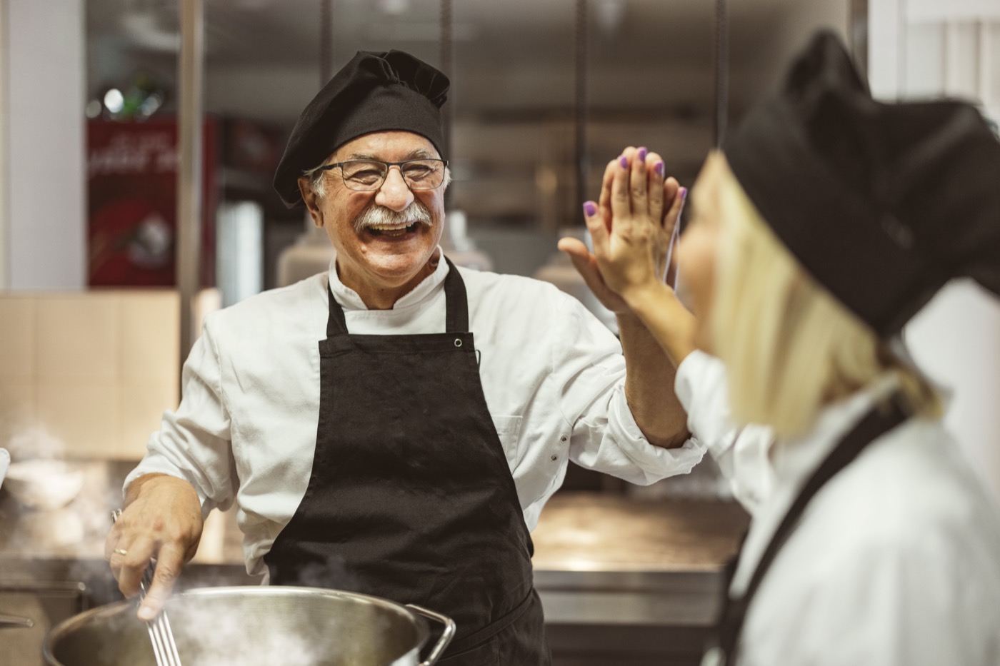 Chef and staff engaging in food preparation