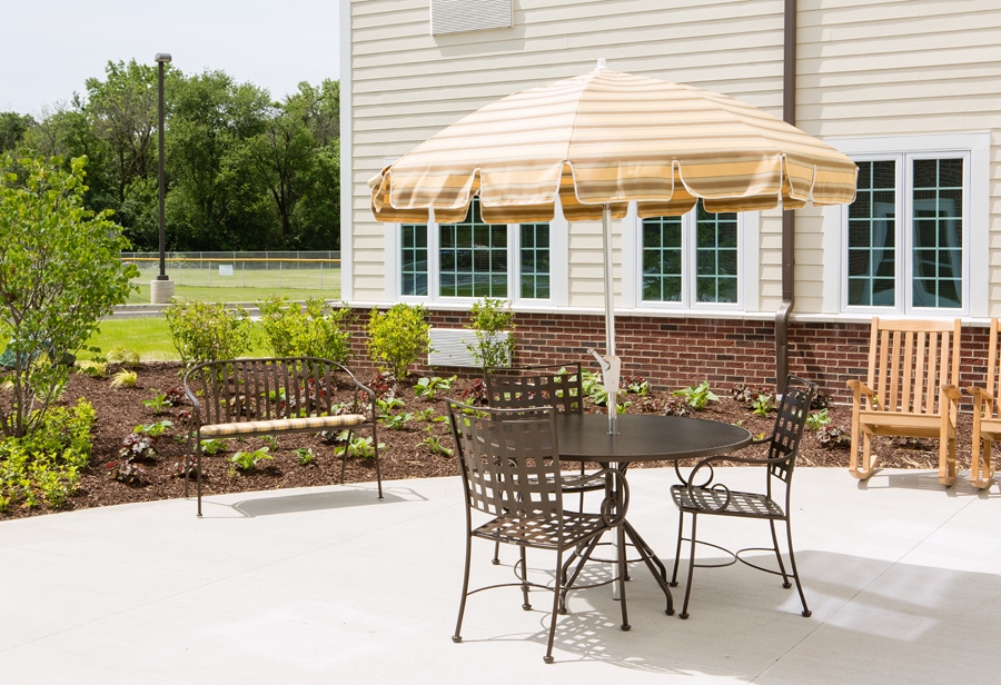 Outdoor seating area with tables and umbrella