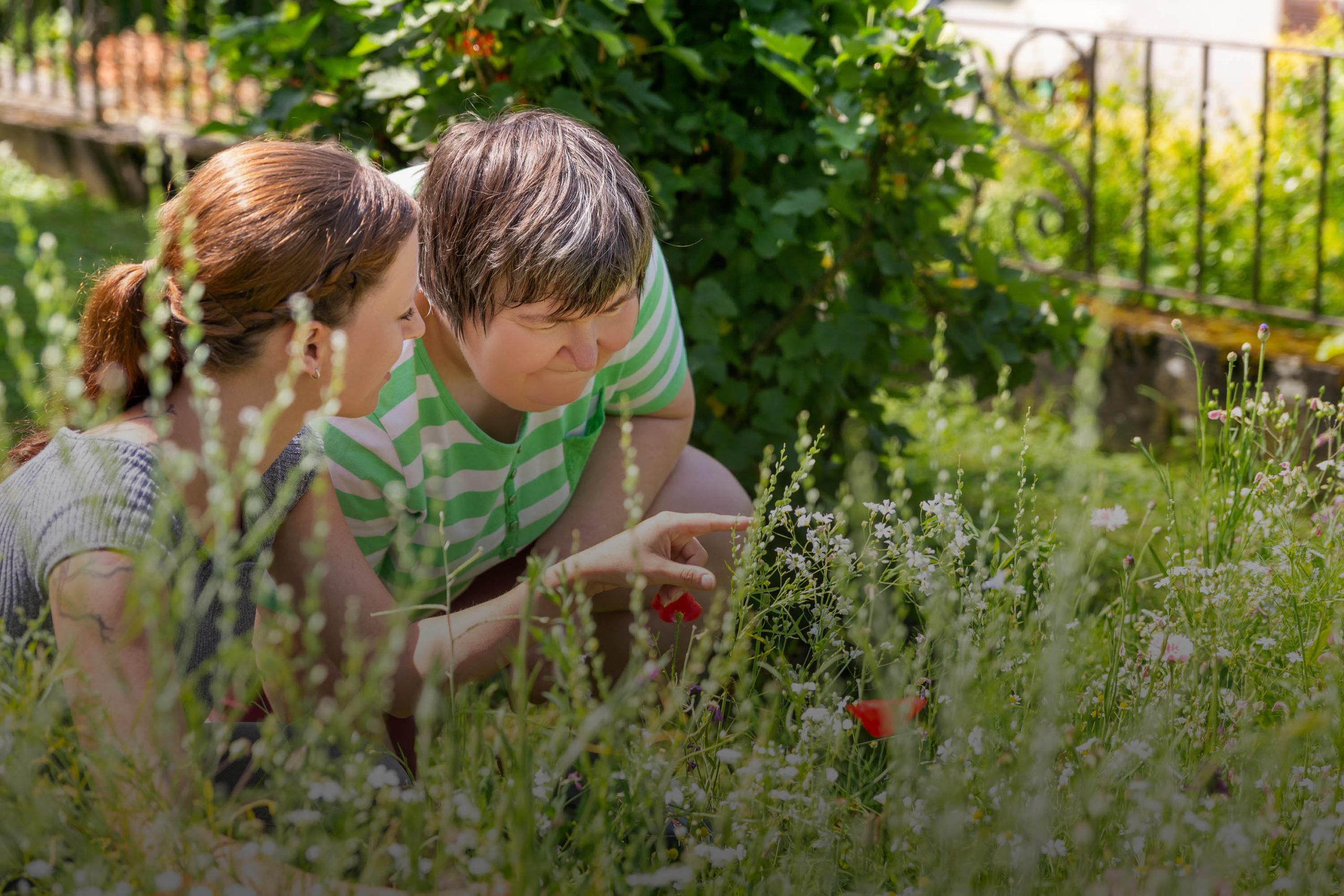 Two people enjoying time outdoors in a garden