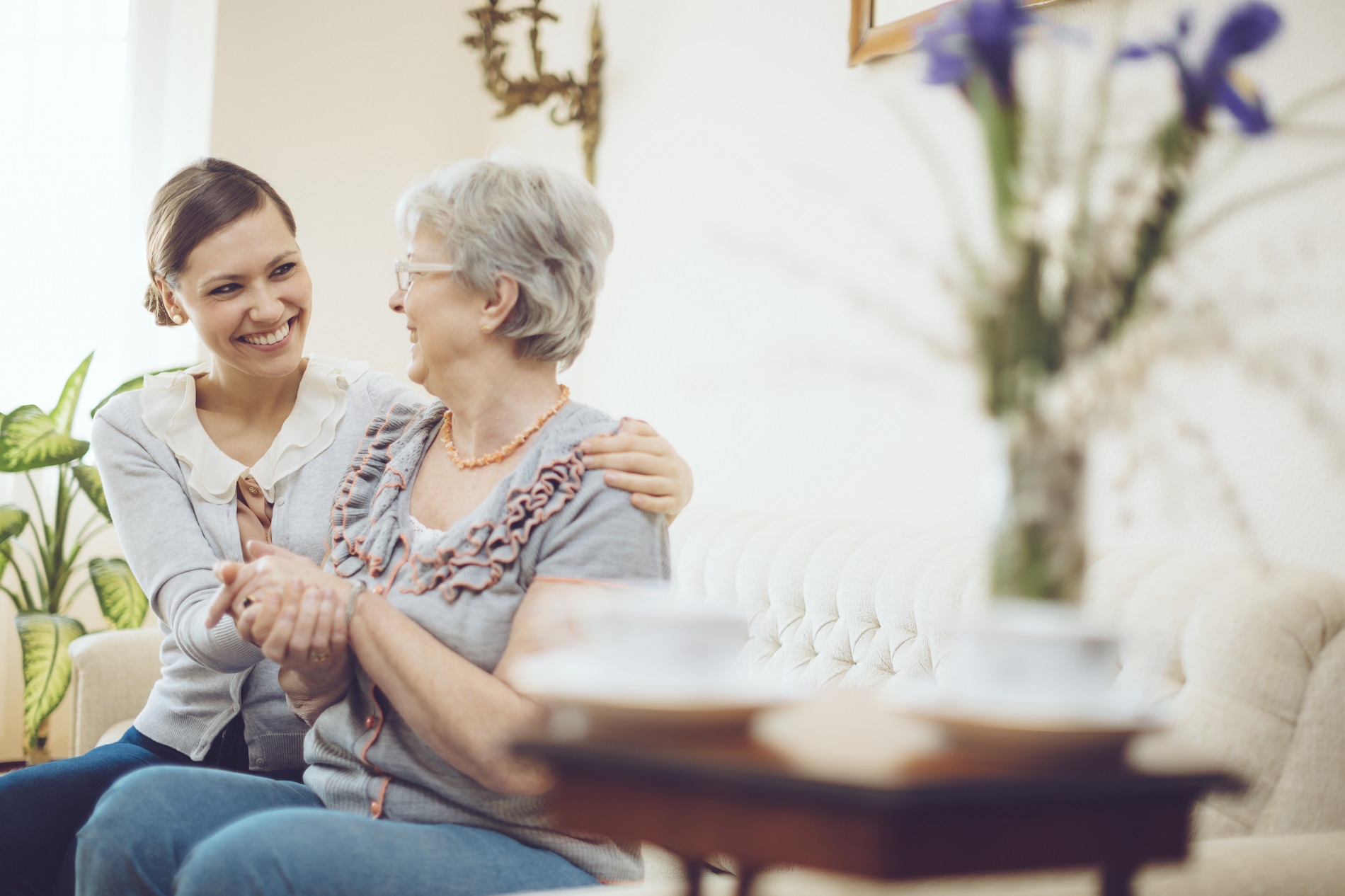 Smiling caregiver with elderly resident indoors