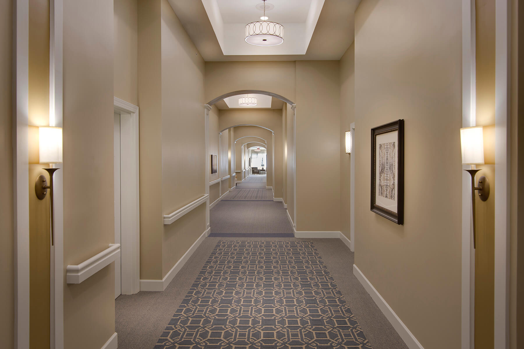 Well-lit hallway with stylish decor and artwork.