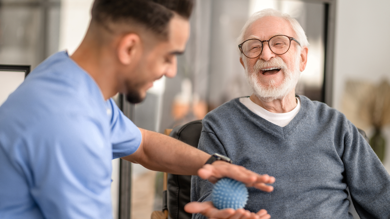 Staff member engaging with a smiling resident