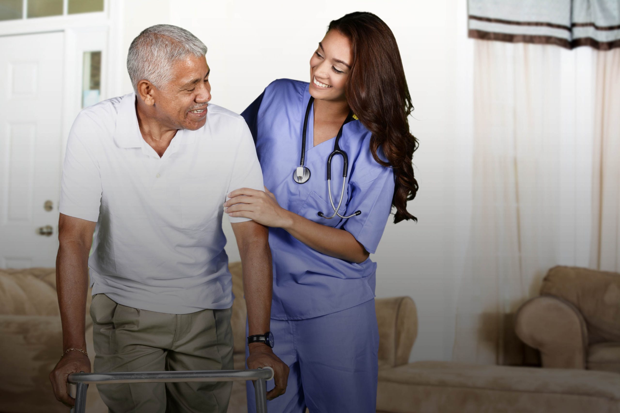 Caregiver assisting a resident in a common area.