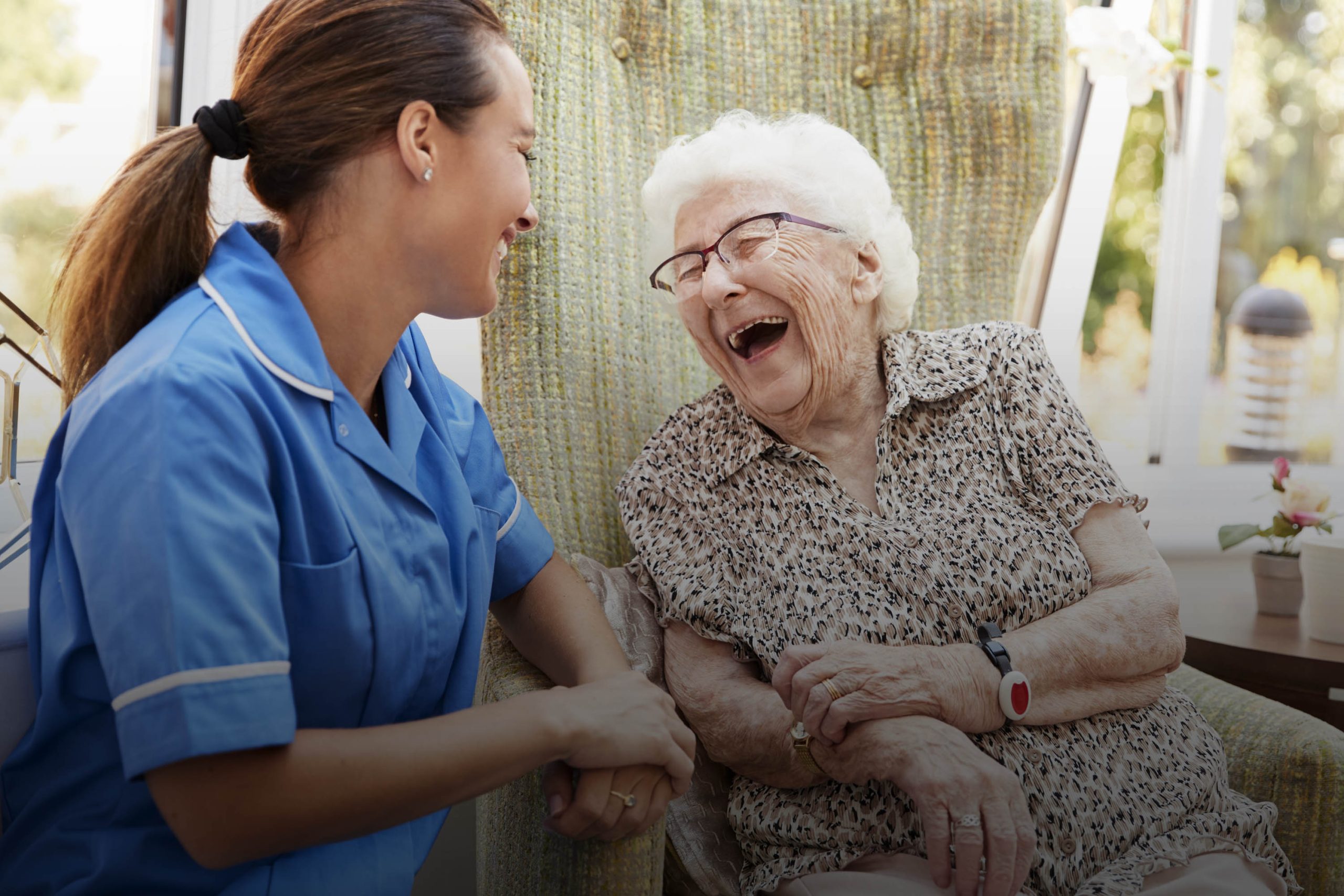 Staff member laughing with elderly resident