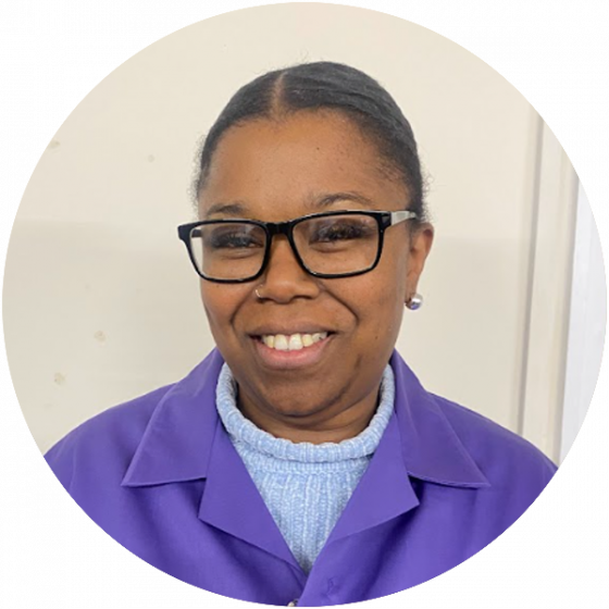 Smiling staff member in purple uniform