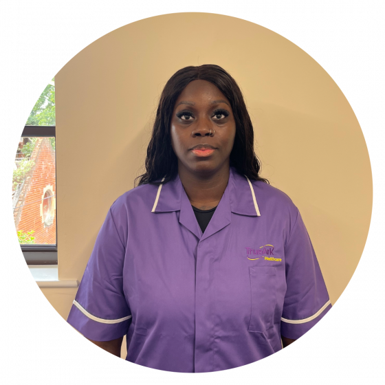 Staff member in a purple uniform indoors