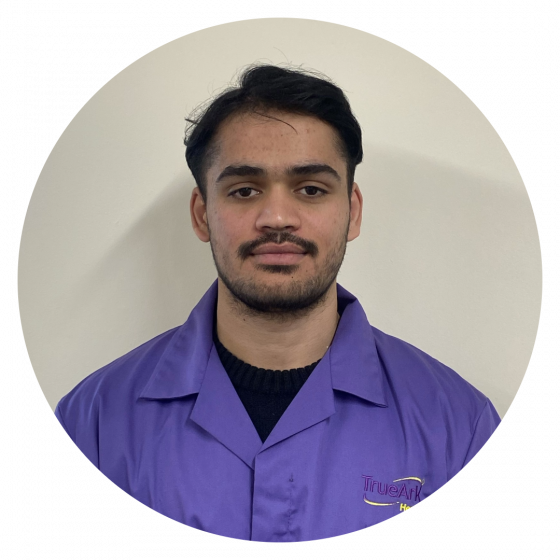 Staff member in uniform with facility logo