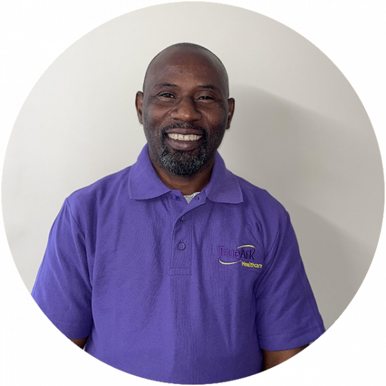 Staff member smiling in a purple shirt