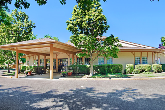Exterior view of Brookdale Grand Prairie entrance with trees