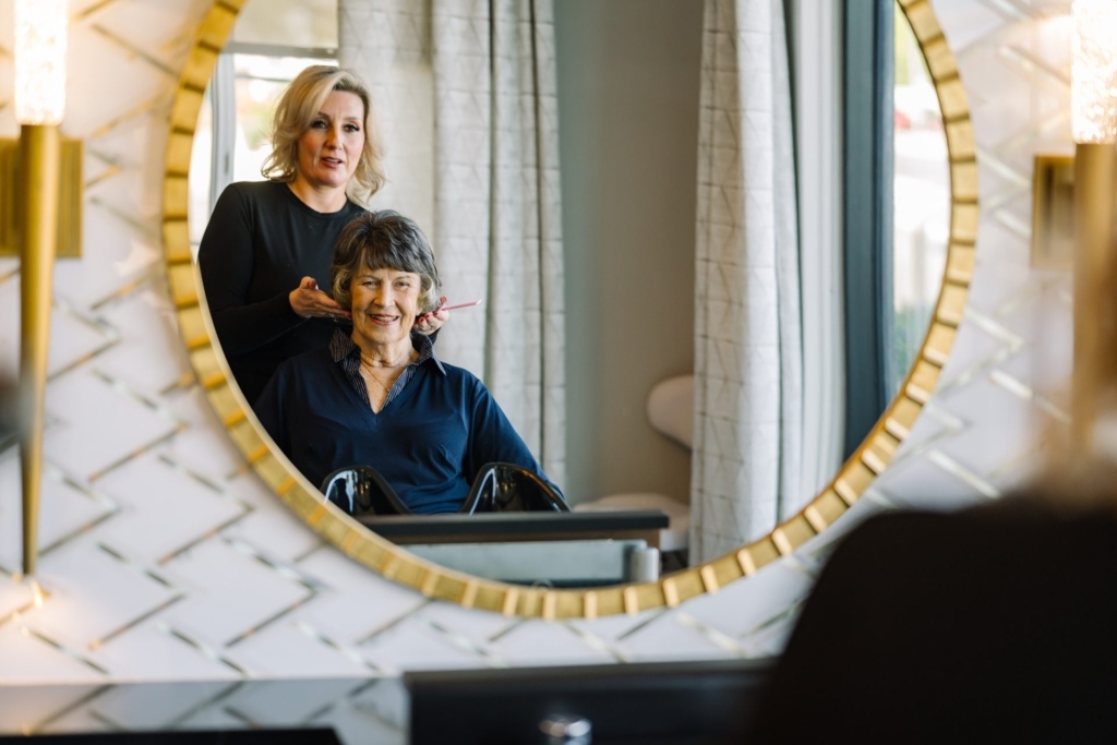 Resident receiving a hair treatment in a salon