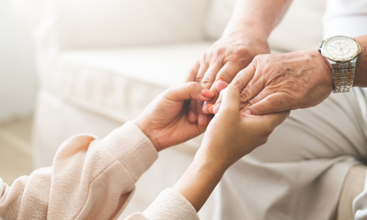 A close-up of hands being held.