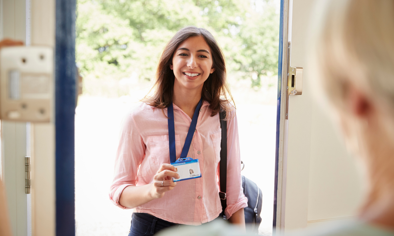 Staff member greeting resident at the door