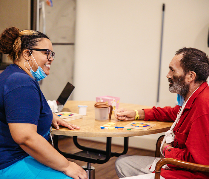 Staff and resident engaging in a game