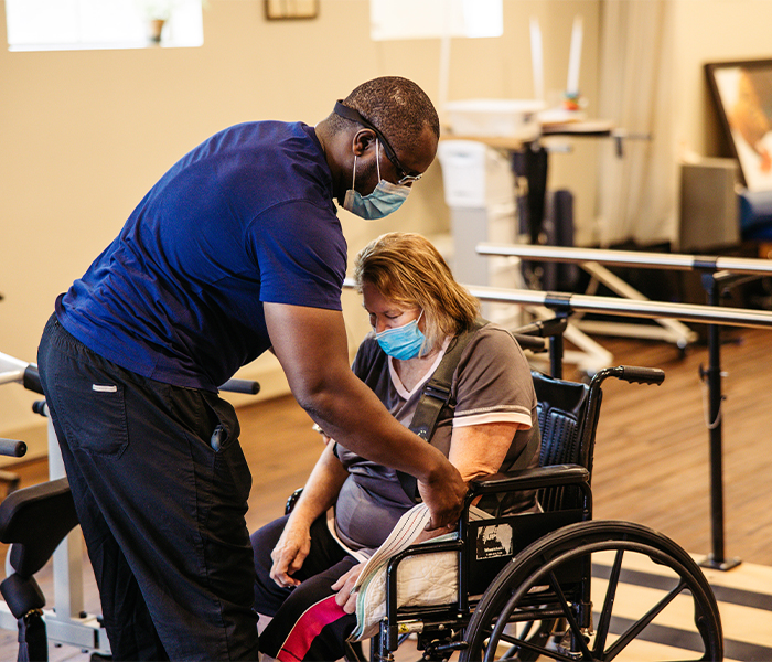 Staff assisting a resident in a therapy session