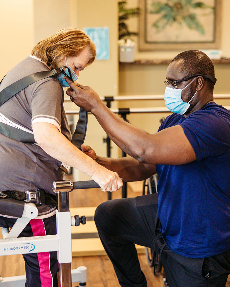 Staff assisting resident in a therapy session.