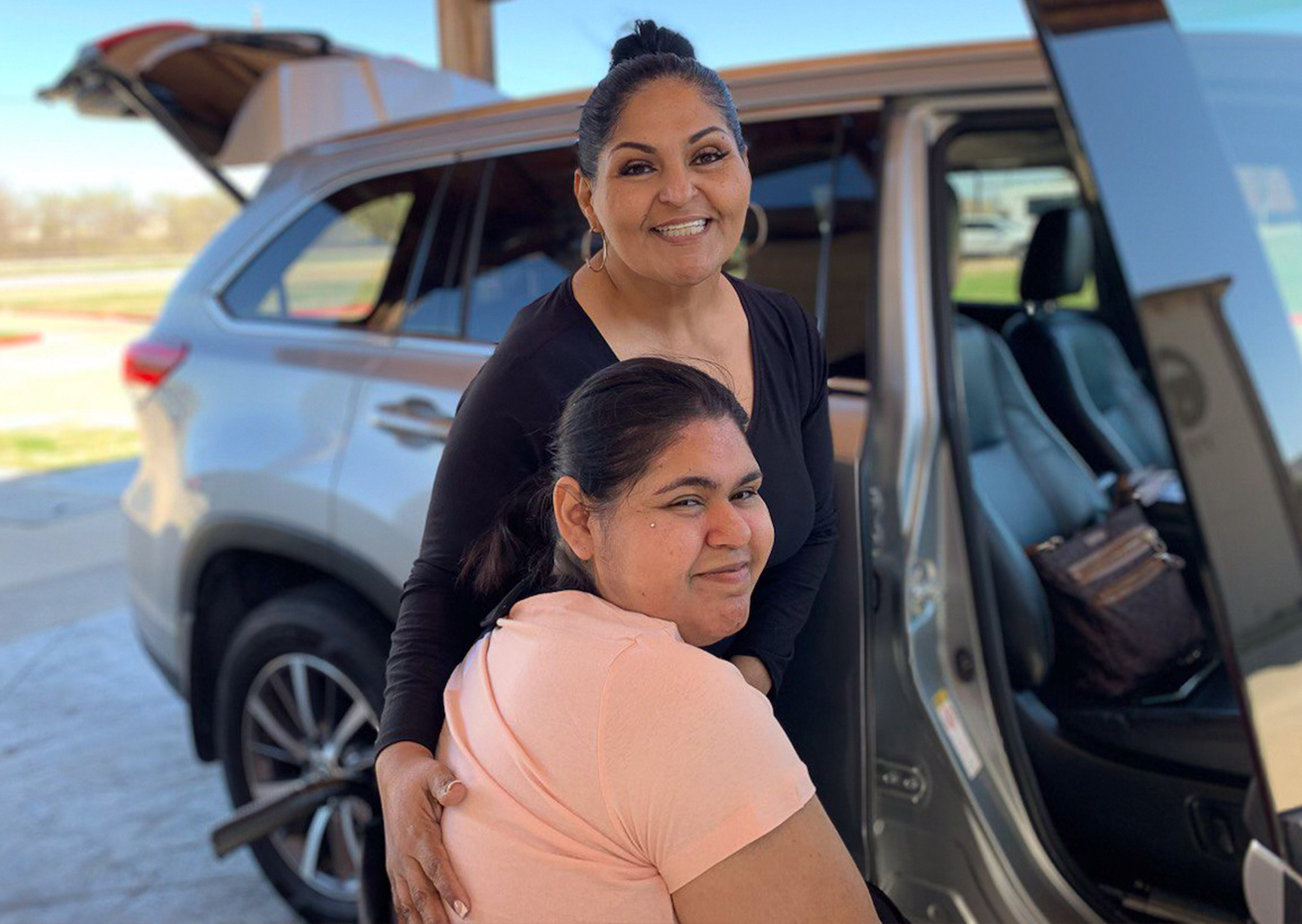 Caregiver assisting a resident at a vehicle