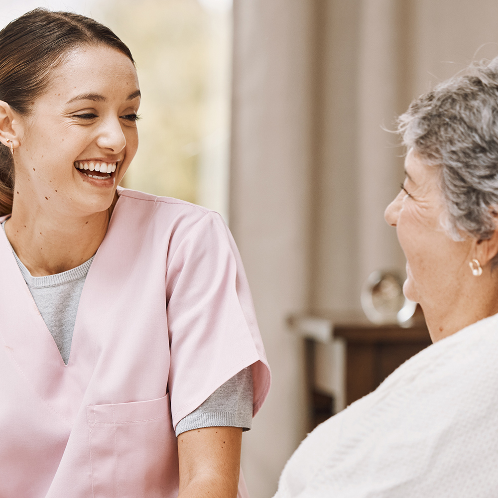 Nurse joyfully interacting with a senior resident