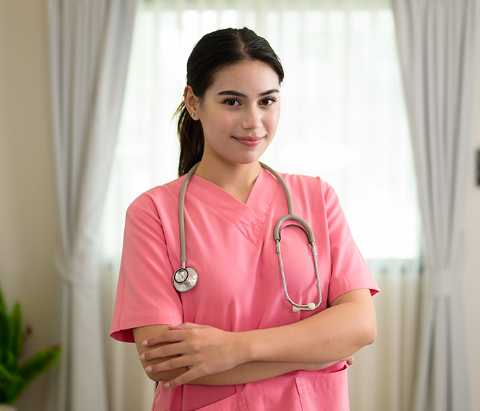 Nurse in pink scrubs with a stethoscope