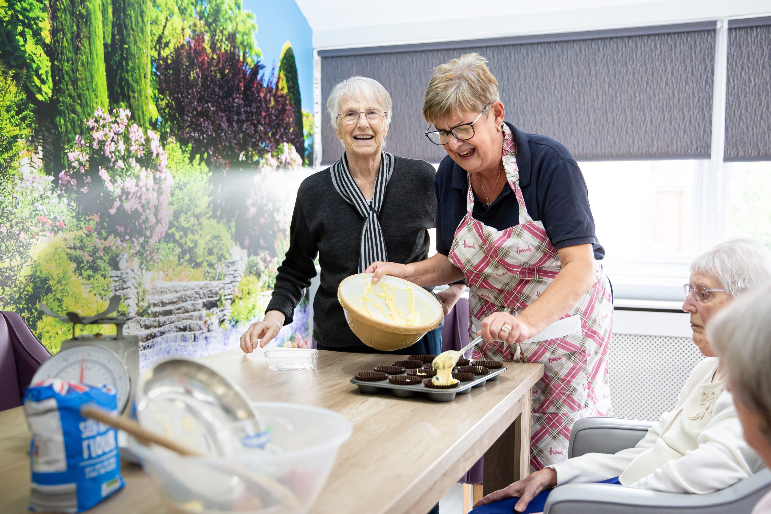 Residents and staff baking together in the kitchen