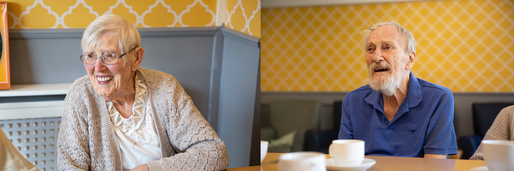 Two smiling elderly residents in a social setting.