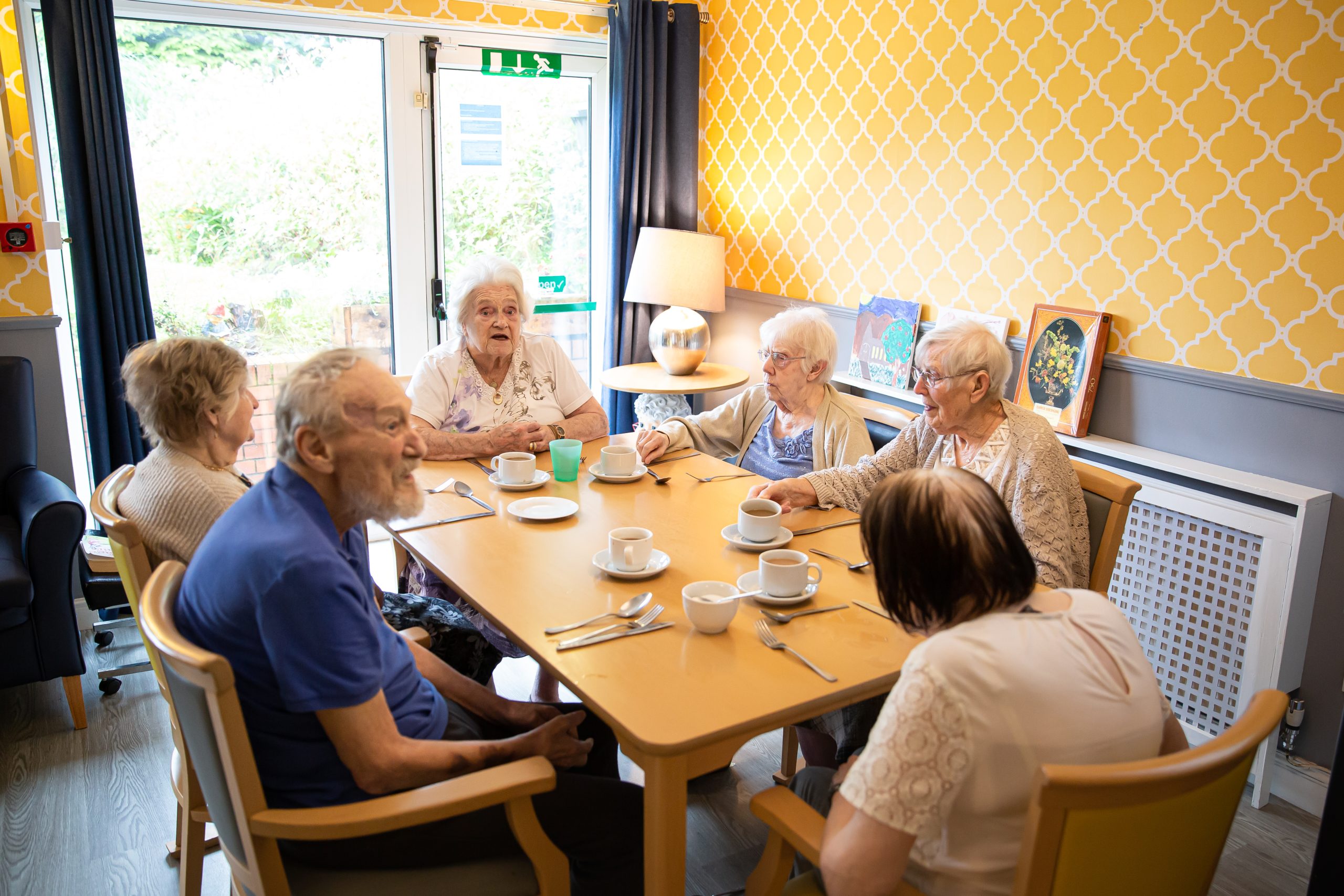 Residents enjoying a meal together in a dining area.