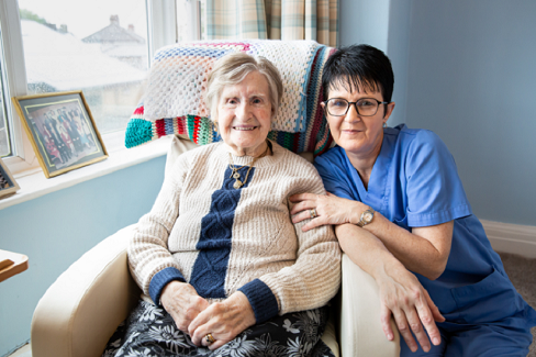 Resident and staff member sharing a smile
