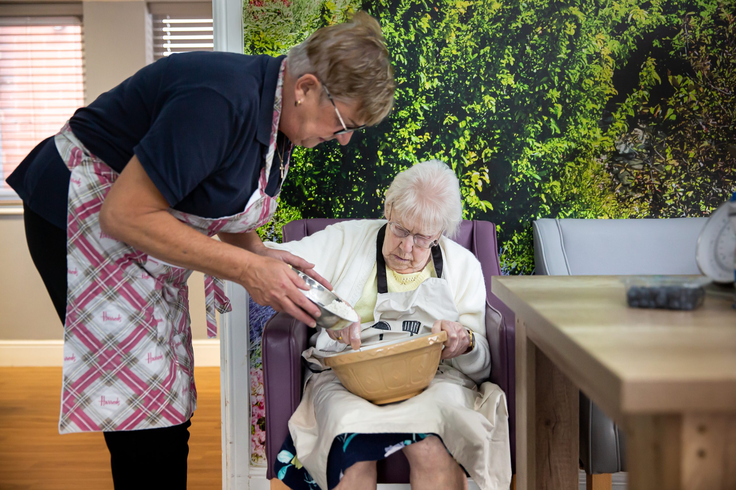 Staff member assisting resident with an activity.