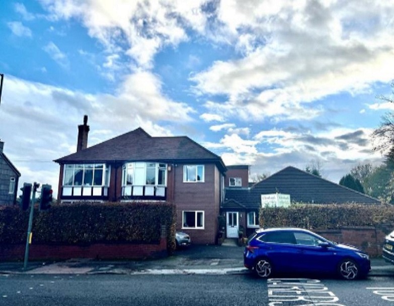 Exterior view of Glenbank Care Home with car parked