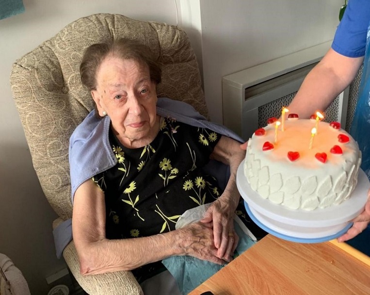 Resident celebrating a birthday with a cake.